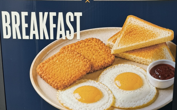 Laughably fake plastic looking breakfast plate with egg and hash brown textures that do not exist in reality