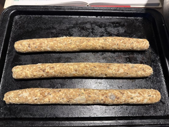 3 roll of veggie sausage roll mix ready on a tray for chilling. 