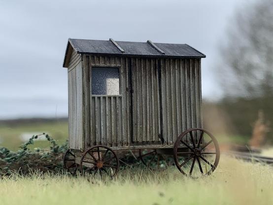 Model of an old shepherds hut on scenic base.